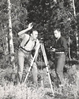 1951 photograph of College of Forestry. Robert McMahon and James Kuechmann surveying in the forest. Donor: Publications Dept.