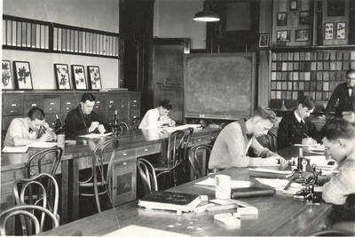 1928 photograph of College of Forestry. Students studying during wood technology class.