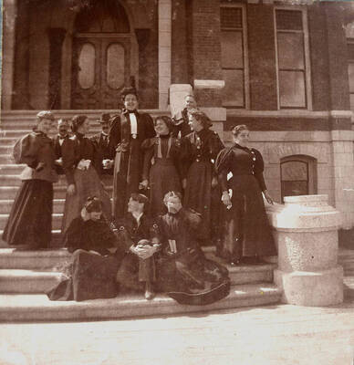1897-06-13 photograph of Home Economics. Home Economics students on the steps of the Administration building