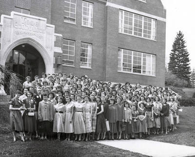 1950 photograph of Home Economics. Students outside Home Economics building. Donor: Publications Dept.