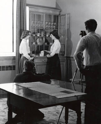 1954 photograph of Home Economics. Malcolm Faust and Frederick Williams photograph Joyce Genoway and Donna Hansen. Donor: Publications Dept.