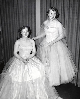 1955 photograph of Home Economics. Theresa Matthieson and Shirley Lenz model formal dresses they designed, wove, and made Donor: Publications Dept.