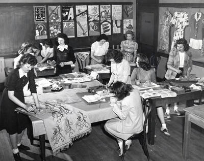 1943-05-17 photograph of Home Economics. Students work at tables during art and design class. Donor: Publications Dept.