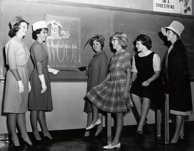 1962 photograph of Home Economics. Students modeling wool dresses. Donor: Publications Dept.