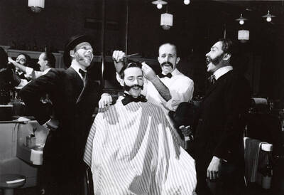 1942 photograph of Music Department. Old Barbershop Quartet includes Alvah A. Beecher, Carl Claus, Lee Gibson, and Robert Walls rehearsing for the Red Cross Benefit Concert.
