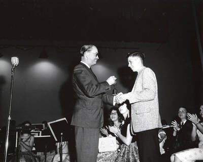 1951 photograph of Music Department. Hall Macklin presenting a summer music camp award to George Davidson. Donor: Publications Dept.