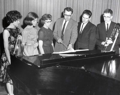 1961 photograph of Music Department. Gay R. Silha, Pat Cannon, Angela Sherbenou, LeRoy Bauer (conductor), James Schoepflin, Harry Betts. Donor: Publications Dept.