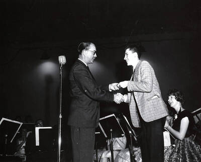 1951 photograph of Music Department. Hall Macklin presenting a summer music camp award to Todd Bake. Donor: Publications Dept.