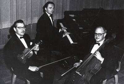 1961 photograph of Music Department. Music Faculty Trio LeRoy Bauer, David Tyler, and David Whisner with their instruments. Donor: Publications Dept.