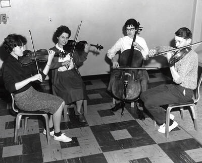 1954 photograph of Music Department. Student string quartet practicing. Donor: Publications Dept.