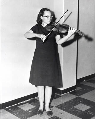 1955 photograph of Music Department. Violinist practicing. Donor: Publications Dept.