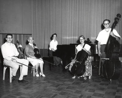 1952 photograph of Music Department. Piano quintet LeRoy bauer, unidentified, Marian Frykman, David Whisner, and an unidentified man on stage. Donor: Publications Dept.