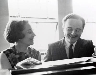 1963 photograph of Music Department. Paula and David Tyler at a piano. Donor: Publications Dept.