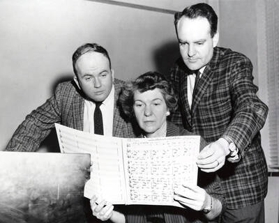 1958 photograph of Music Department. Charles Walton, Marian Frykman, and William Billingsley studying a score by Billingsley Donor: Publications Dept.