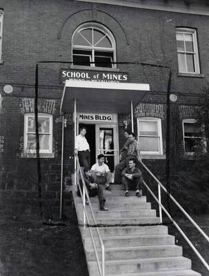 1953 photograph of College of Mines. Students in the entryway of the School of Mines building.