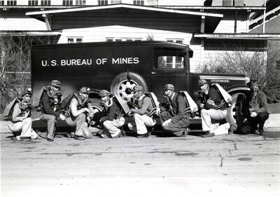 1930 photograph of College of Mines. Students in mine rescue course in front of U.S. Bureau of Mines rescue truck.