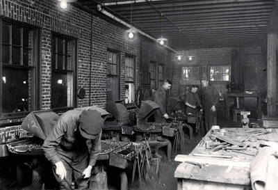 1922 photograph of College of Engineering. Students working in the forge shop.