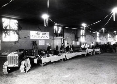 1933 photograph of College of Engineering. Students with the Motor mechanics class exhibit.