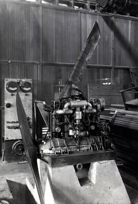 1939 photograph of College of Engineering. An airplane engine in the shop.
