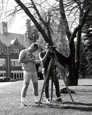 1964 photograph of College of Engineering. Students surveying in front of the Administration building. Donor: Publications Dept.
