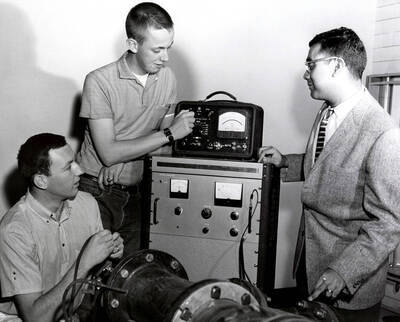1965 photograph of College of Engineering. James Okeson, David D. Powers, and Godfrey Q. Martin checking a hot film anemometer.