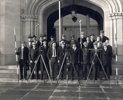 1911 photograph of College of Engineering. Students with survey equipment on the steps of the Administration building. Students are labeled 1. V. Samms 2. S. Regan 3. W. Scott 4. B. Kinnison 5. T. Doyle 6. W. Murray 7. G. Scott 8. D.B. Steinmann 9. A. Cooper 10. R. Tuttle 11. H.B. Soulen 12 C. Lewis 13. V. Fawcett 14 B. Wookridge 15. R. Perkins. Donor: From Dean Janssen's papers.