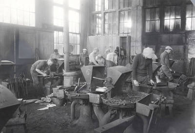 1922 photograph of College of Engineering. Students working in the forge shop.