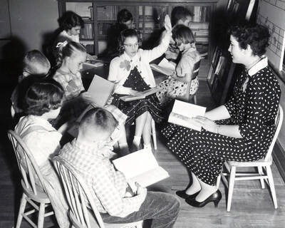1953 photograph of College of Education. A student teacher instructs a classroom.