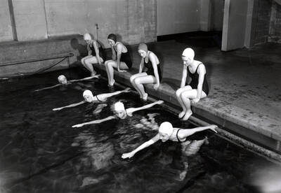 1936 photograph of Physical Education. Female students swimming.