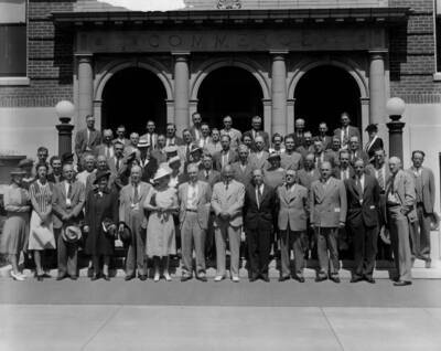 1940 photograph of Agricultural Extension Service. Conference group photograph. 58 people are indentified on the back of the photograph. Back Row (left to right): Horace G. Boldter (Montana), Wm. C. Ockey (Washington D.C.), C. O. Youngstrom (Idaho), O. T. McWhorter (Oregon), Thomas E. Buckman (Nevada), N. D. Thomas (Oregon), B. H. Crocheron (California), Chas. Pickrell (Arizona), J. M. Clifford (Oregon), H. H. White (Oregon), D. C. Mumford (Oregon); Row 4 (left to right): H. W. Gilbertson (Washington D.C.), L. H. Cline (Nevada), R. S. Besse (Oregon), R. M. Turner (Washington), Howard R. Baker (Arizona), M. Irene Leach (Oregon), Mabel Mack (Oregon), Paul Carpenter (Oregon), Buena Maris (Oregon), Effie S. Barrows (Utah); Row 3 (left to right): N. L. Bennion (Oregon), Mary Rokahr (Washington D.C.), Hellen Gillette (Nevada), Jean Warren (California), Arthur J. Cagle (Washington), J. C. Taylor (Montana), K. E. Morrison (Wyoming), J. R. Beck (Oregon), W. W. Owens (Utah); Row 2 (left to right): Exine Davenport (Colorado), Virgil Gilman (Washington D.C.), Lois Lutz (Oregon), Marian Hepworth (Idaho), Mrs. T. H. Summers (Colorado), T. H. Summers (Colorado), Ellen Lindstrom (Wyoming), Mary S. Buol (Nevada), J. C. Bower (Montana), A. E. Bowman (Wyoming), Esther Pond (Washington), Arthur Shultis (California), John B. Schneider (California), Chas. W. Smith (Oregon), Paul Eke (Idaho); Row 1 (left to right): M. Elmina White (Washington), Miss Taylor (Montana), Fred Jans (Colorado), Margaret H. Tuller (Montana), A. B. Fite (New Mexico), Azalea Sager (Oregon), M. L. Wilson (Washington D.C.), Wm. A Schoenfeld (Oregon), E. J. Iddings (Idaho), F. E. Balmer (Washington), Wm. L. Tautsch (Oregon), H. W. Hochbaum (Washington D.C.), and E. R. Jackman (Oregon). Donor: University of Idaho Cooperative Extension System.