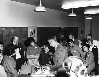 1966 photograph of Art and Architecture. Alfred Dunn demonstrating his painting technique to students during class. Donor: Publications Dept.