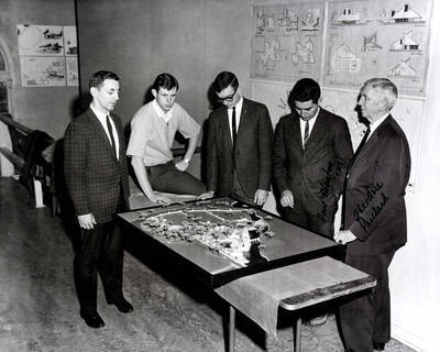 1967 photograph of Art and Architecture. William McCroskey, Paul Blanton, Theodore Prichard, and two unidentified men examining a model of a map. Donor: Publications Dept.