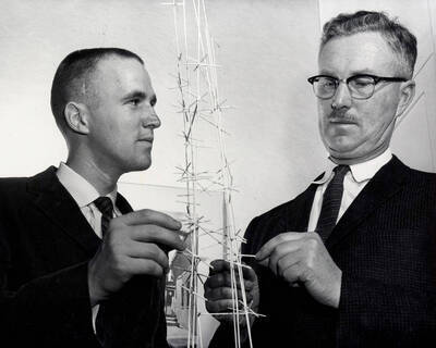 1961 photograph of Art and Architecture. Iain Baxter and Alf Dunn examine a sculpture. Donor: Publications Dept.