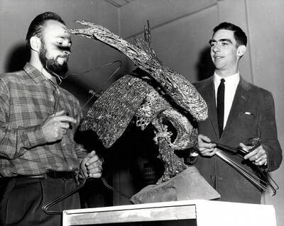 1962 photograph of Art and Architecture. George Roberts and a student look at a sculpture of a bird. Donor: Publications Dept.