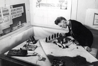 1936 photograph of Art and Architecture. Richard Maxwell finishing a model of a building. Donor: Publications Dept.