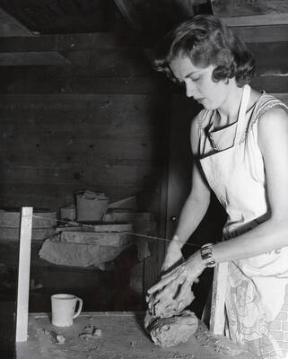 1949 photograph of Art and Architecture. A student preparing clay. Donor: Publications Dept.