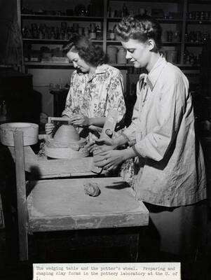 1947 photograph of Art and Architecture. Two students work at a wedging table and a potter's wheel. Donor: Publications Dept.