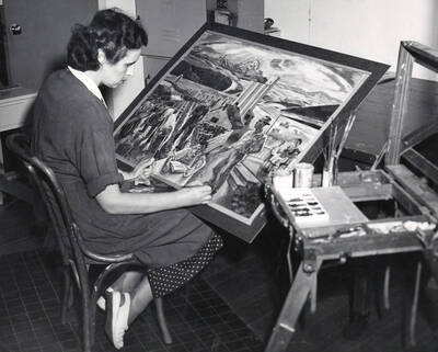 1970 photograph of Art and Architecture. Mary Kirkwood painting in a studio. Donor: Publications Dept.