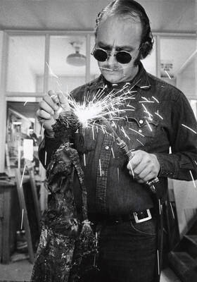 1974 photograph of Art and Architecture. Bill Snyder welding a sculpture.