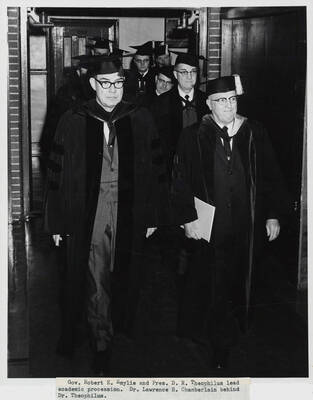 1964 photograph of 75th Anniversary. Governor Robert E. Smylie and President D.R. Theophilus in academic regalia leading a procession.
