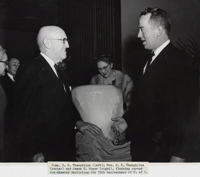 1964 photograph of 75th Anniversary. Dr. and Mrs. D. R. Theophilus with James Roper.