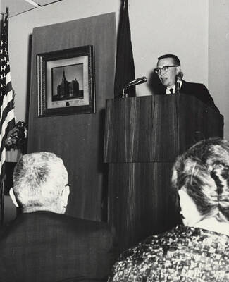 1964 photograph of 75th Anniversary. A speaker at a podium during the 75th Anniversary.