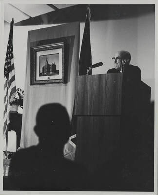 1964 photograph of 75th Anniversary. President D.R. Theophilus giving a speech from a lectern.
