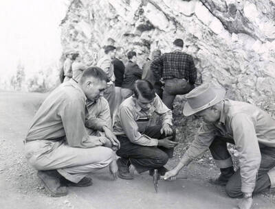1953 photograph of Geology. Jack Hooks, Garfield Johnson, and S. Warren Hobbs during a geology field trip near Wallace, Idaho. Donor: Publications Dept.