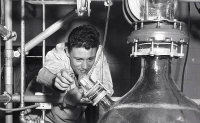 1969 photograph of Chemical Engineering. William J. Thompson operating experimental equipment.