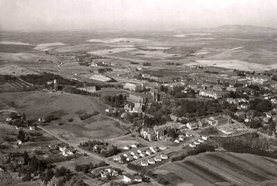 1954 photograph of University of Idaho campus. Aerial view shows both water towers on campus. Donor: Publications Dept.