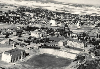 1932 photograph of University of Idaho campus. Aerial view shows both campus and Moscow looking northeast.