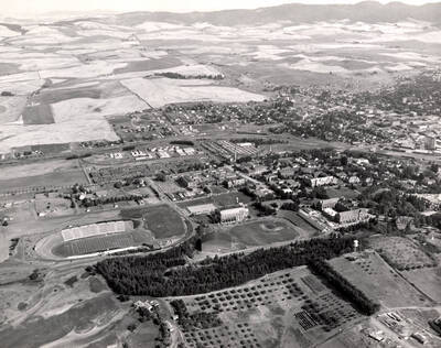 1951 photograph of University of Idaho campus. Aerial view shows both campus and Moscow.