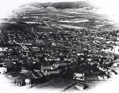 1961 photograph of University of Idaho campus. Aerial view shows baseball diamond and grandstands on left.