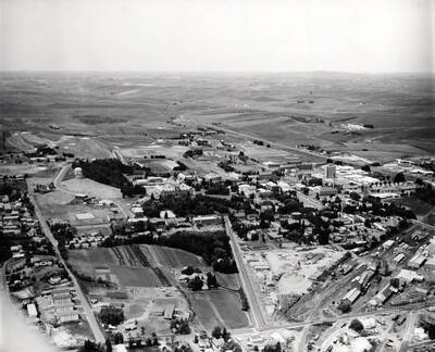 1961 photograph of University of Idaho campus. Aerial view shows both campus and the surrounding fields.